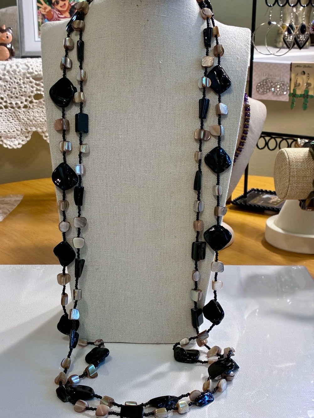 This statement piece is a long, double strand bohemian sweater necklace.